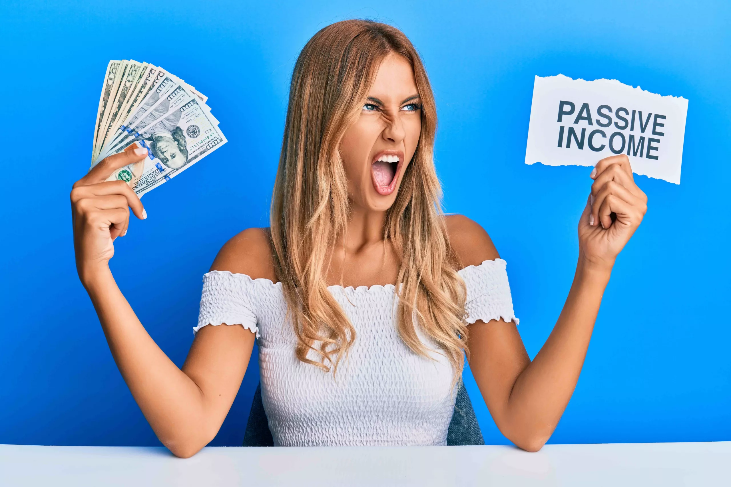 Passive Income - Woman Holding Money and Passive Income Sign