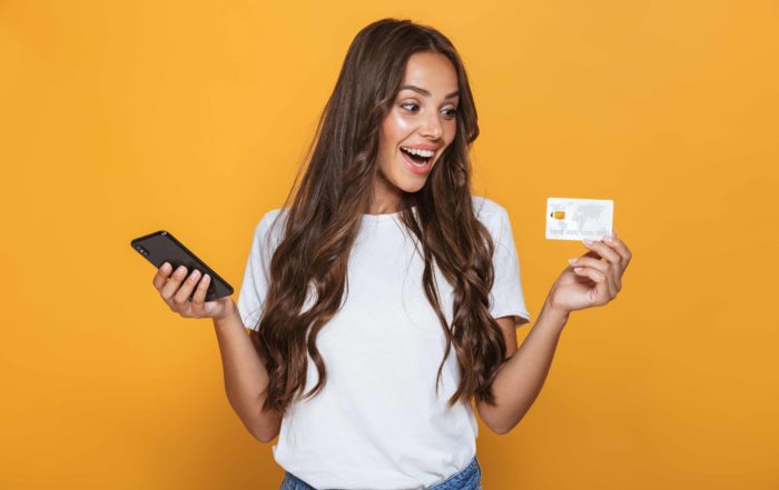 Debit Card - Latina X woman smiling with a debit card